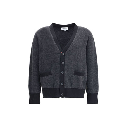 Thom Browne Black Fleece Wool Cardigan featuring V-neck and front button closure with patch pockets, ribbed cuffs, and hem.