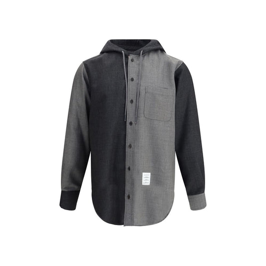 Thom Browne Hooded Shirt Jacket with patch pocket and asymmetrical hem in black and grey, featuring adjustable hood and button closure.