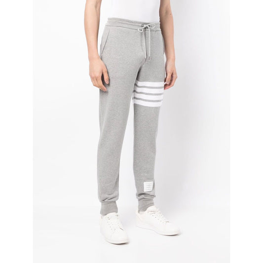 Thom Browne Trousers Grey with signature 4-Bar stripe and drawstring waist, shown from the front, featuring side and rear pockets.