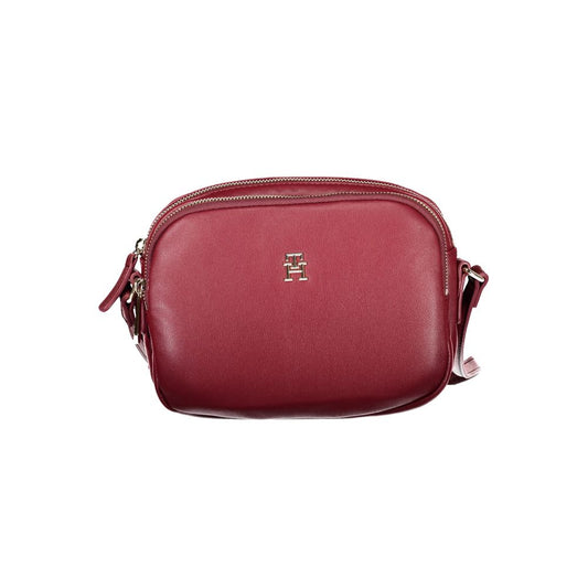 Tommy Hilfiger Red Polyester Handbag with adjustable strap, two compartments, internal pocket, and zip closure.