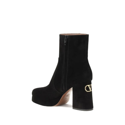 Valentino Garavani Black Calf Leather Bos Taurus Ankle Boots with VLogo detail and side zipper closure for elegance and comfort.