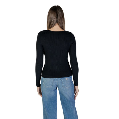 Back view of a woman wearing Vila Clothes Black Viscose Sweatshirt with ribbed design and asymmetric neckline, paired with blue jeans.