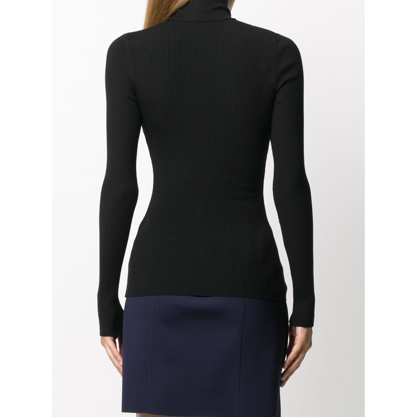 Rear view of a woman wearing a Wolford Sweaters Black virgin wool ribbed knit turtleneck with long sleeves, paired with a skirt.