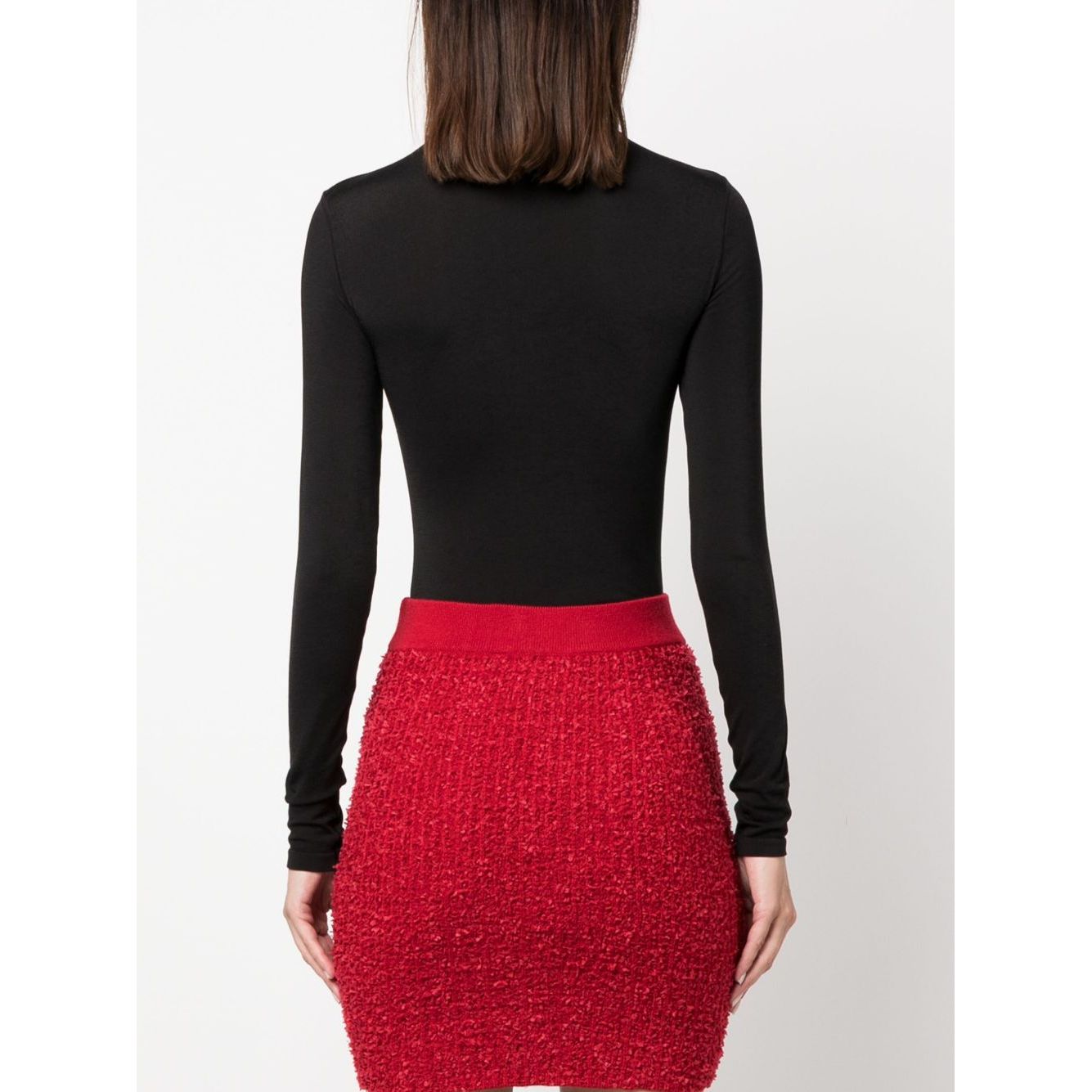 Back view of Wolford Top Black bodysuit with long sleeves and roll neck, worn with a red textured skirt. Features a sleek cotton blend design.
