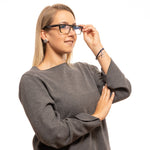 Woman wearing Yohji Yamamoto Brown Women Glasses Frame, full-rim rectangle style, with plastic brown frames, demo lenses.
