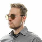 Man wearing Yohji Yamamoto Gray Men Sunglass with gunmetal round frame and gold mirrored lenses.