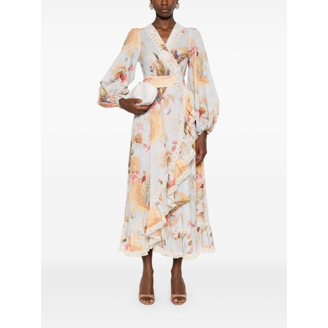 Zimmermann Ascension Ruffled Midi Dress in light blue with floral print, wrap design, and lace trim, modeled by woman holding clutch.