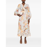 Zimmermann Ascension Ruffled Midi Dress in light blue with floral print, wrap design, and lace trim, modeled by woman holding clutch.