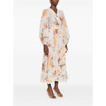 Zimmermann Ascension Ruffled Midi Dress in light blue with floral print and lace trim, wrap design, worn by model, side view.