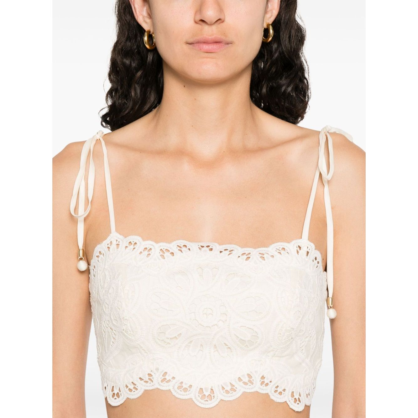 Zimmermann Cropped top with beige tie-fastening straps, floral cut-out detailing, lettuce hem, and Rhiannon embroidered bodice.