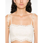 Zimmermann Cropped top with beige tie-fastening straps, floral cut-out detailing, lettuce hem, and Rhiannon embroidered bodice.